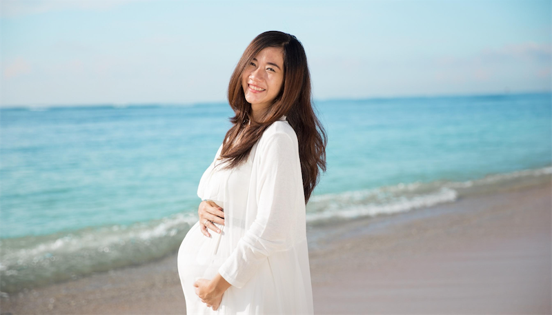 Pregnant woman smiling at dental checkup in Chattanooga - safe dental care during pregnancy at Harrison Family Dentistry